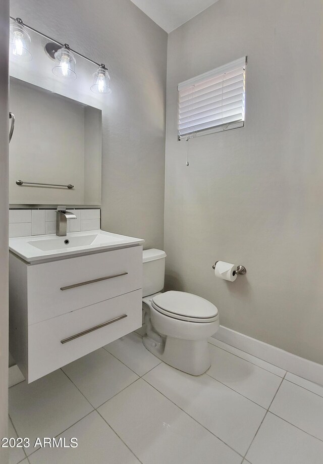 bathroom featuring vanity, tile patterned floors, and toilet