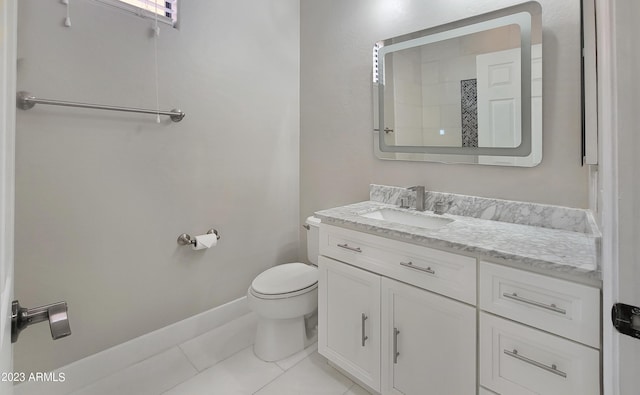 bathroom with vanity, tile patterned flooring, and toilet