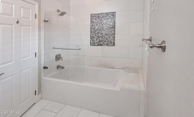 bathroom with tiled shower / bath combo and tile patterned flooring