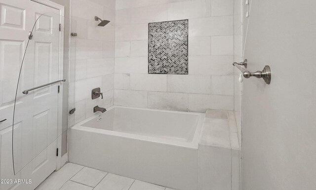 bathroom with tile patterned floors and tiled shower / bath