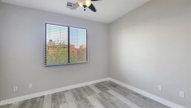 spare room with light hardwood / wood-style flooring and ceiling fan