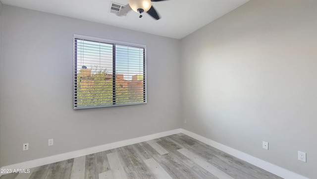 spare room with ceiling fan and light wood-type flooring