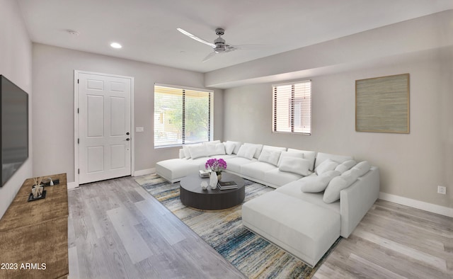 living room featuring light wood-type flooring and ceiling fan