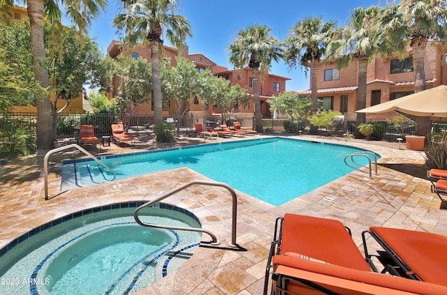 view of swimming pool featuring a community hot tub and a patio