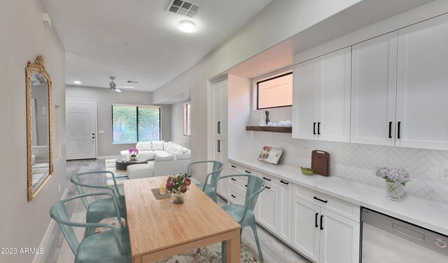 interior space with ceiling fan, white cabinetry, light wood-type flooring, and stainless steel dishwasher