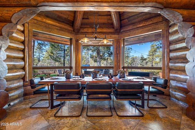 dining room featuring log walls and high vaulted ceiling