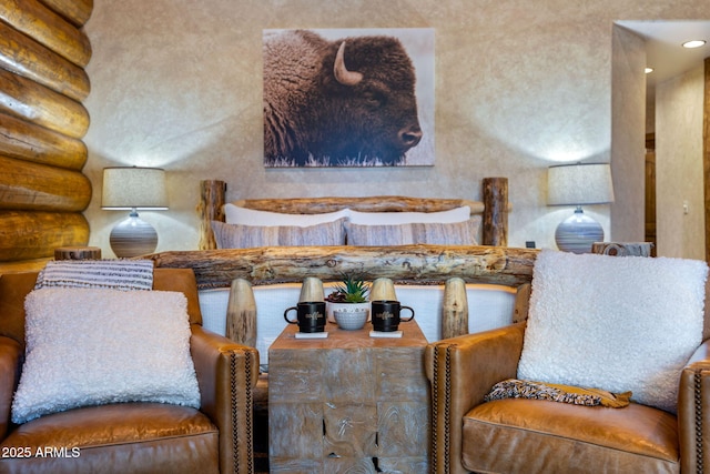 sitting room featuring log walls