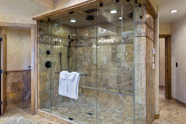 bathroom with a shower with door