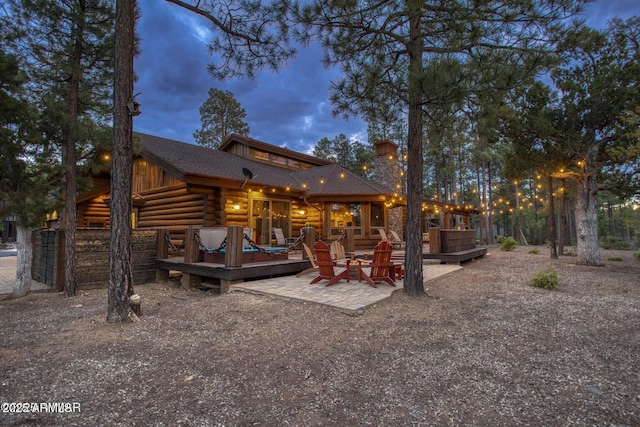 view of back house at dusk