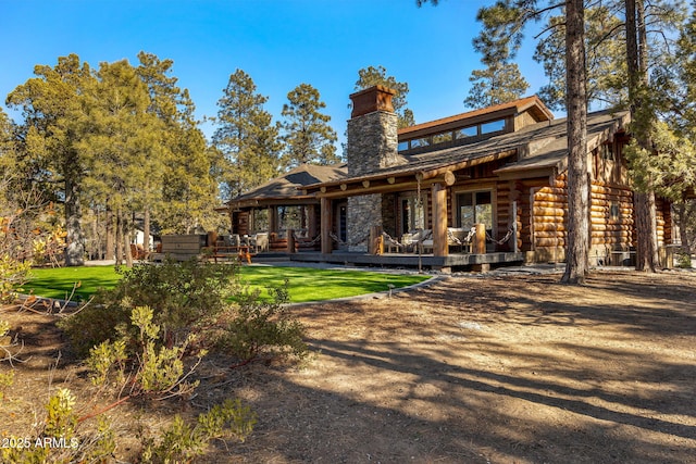 rear view of house with a yard