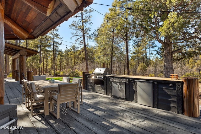 wooden terrace with exterior kitchen and grilling area