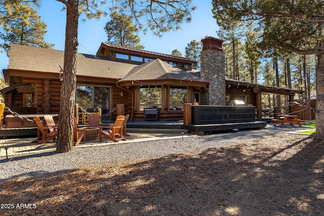 rear view of property featuring a patio area