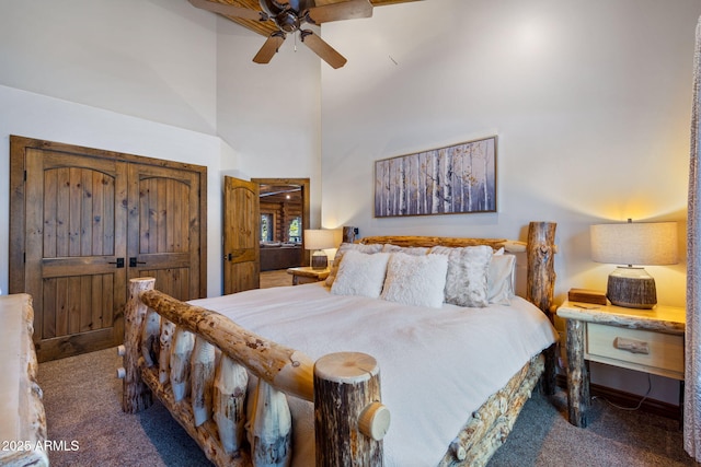 carpeted bedroom featuring a high ceiling and ceiling fan