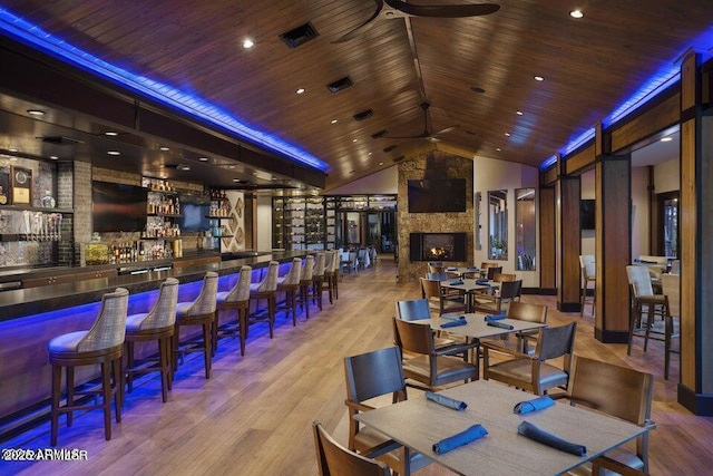 bar featuring ceiling fan, wooden ceiling, vaulted ceiling, and light wood-type flooring