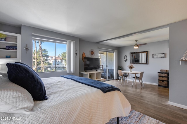 bedroom with hardwood / wood-style flooring and multiple windows