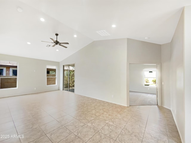 spare room featuring light tile patterned flooring, vaulted ceiling, and ceiling fan