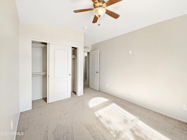 unfurnished bedroom featuring vaulted ceiling, ceiling fan, and light carpet