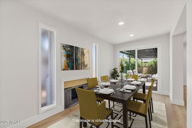 6908 E Windsor Ave, Scottsdale, AZ 85257 - dining area featuring light wood-type flooring, recessed lighting, and a fireplace