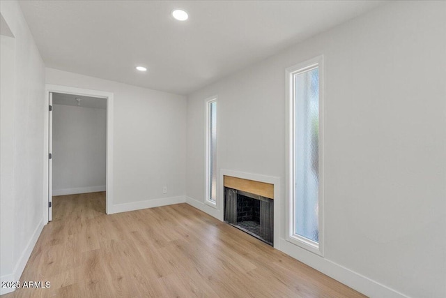 6908 E Windsor Ave, Scottsdale, AZ 85257 - unfurnished living room featuring light wood-type flooring, a fireplace, healthy amount of natural light, and recessed lighting