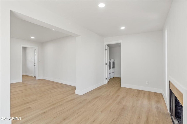 6908 E Windsor Ave, Scottsdale, AZ 85257 - unfurnished living room with washing machine and clothes dryer, recessed lighting, light wood finished floors, and heating unit