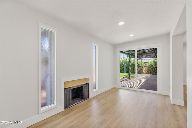 6908 E Windsor Ave, Scottsdale, AZ 85257 - unfurnished living room featuring wood finished floors, a fireplace, and recessed lighting