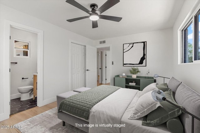 6908 E Windsor Ave, Scottsdale, AZ 85257 - bedroom featuring light wood-style floors, ensuite bathroom, a closet, and a ceiling fan