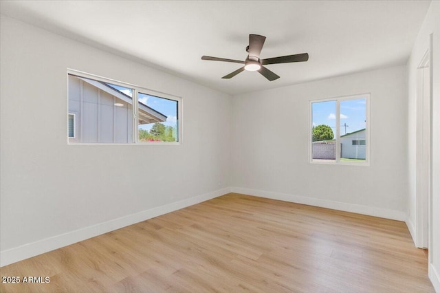 6908 E Windsor Ave, Scottsdale, AZ 85257 - unfurnished room featuring plenty of natural light, light wood-style flooring, and a ceiling fan