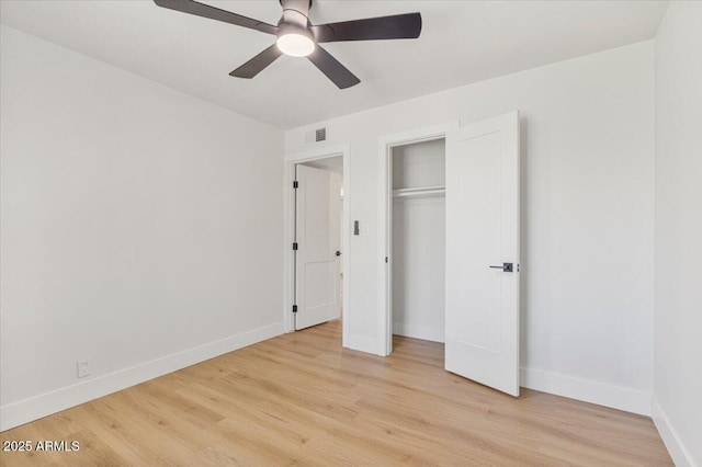 6908 E Windsor Ave, Scottsdale, AZ 85257 - unfurnished bedroom with light wood-type flooring, ceiling fan, and a closet