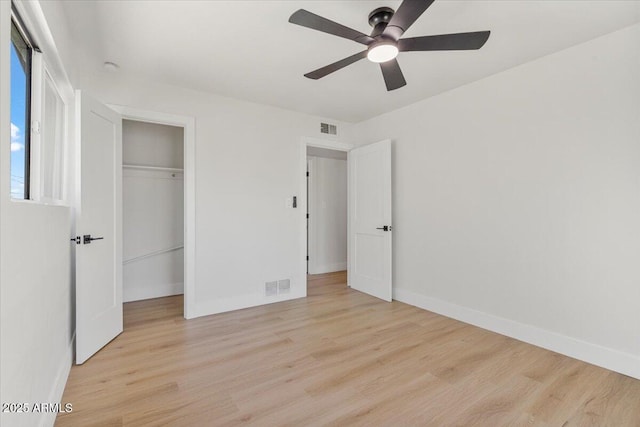 6908 E Windsor Ave, Scottsdale, AZ 85257 - unfurnished bedroom with light wood finished floors, a closet, and ceiling fan
