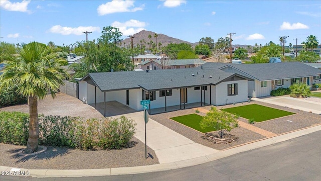 6908 E Windsor Ave, Scottsdale, AZ 85257 - ranch-style home with concrete driveway, a mountain view, a residential view, and a porch