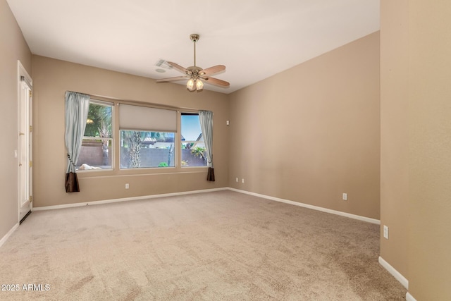 carpeted spare room with baseboards and ceiling fan