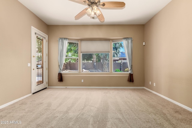 unfurnished room with a ceiling fan, plenty of natural light, and carpet