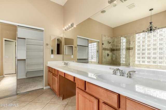 full bath with tile patterned flooring, visible vents, a shower stall, a notable chandelier, and a sink