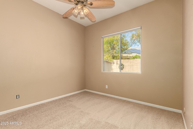 carpeted empty room with baseboards and a ceiling fan