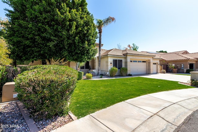 view of front of home with a garage, concrete driveway, a front yard, and stucco siding