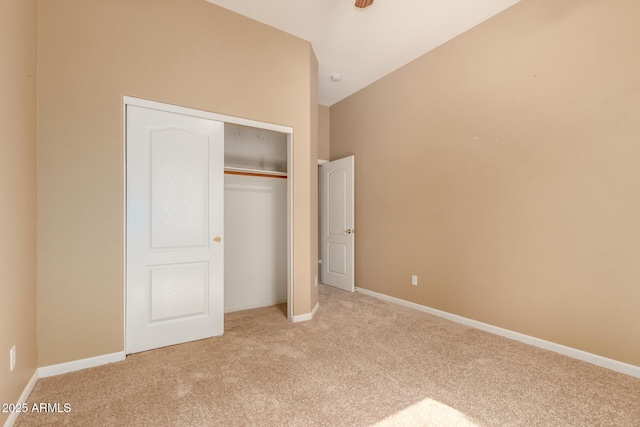 unfurnished bedroom featuring carpet, a closet, and baseboards