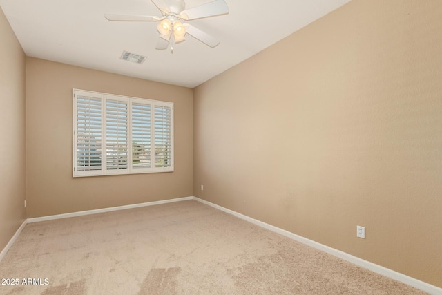 spare room featuring carpet flooring, baseboards, visible vents, and ceiling fan