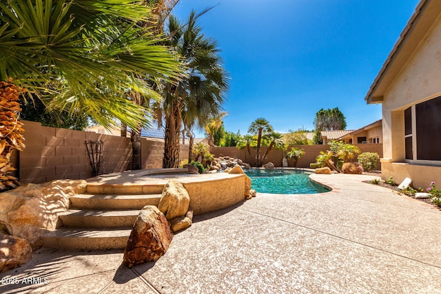 view of swimming pool featuring a patio area, a fenced in pool, and a fenced backyard