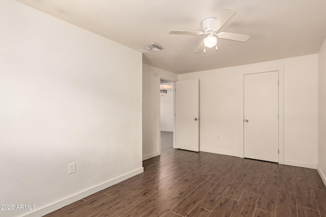 unfurnished bedroom featuring dark hardwood / wood-style floors and ceiling fan