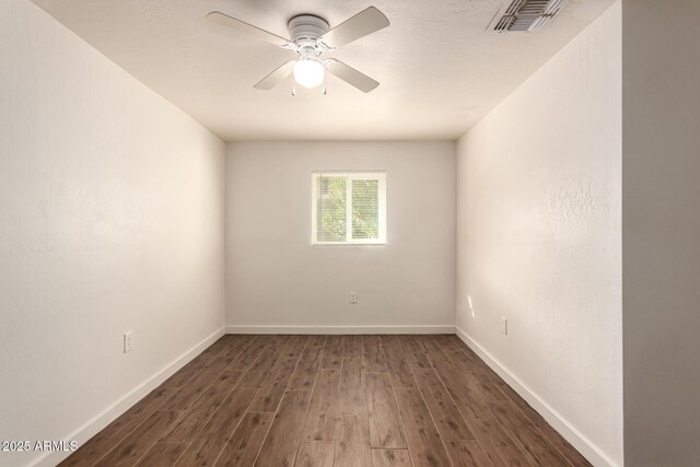 spare room with ceiling fan and dark hardwood / wood-style flooring