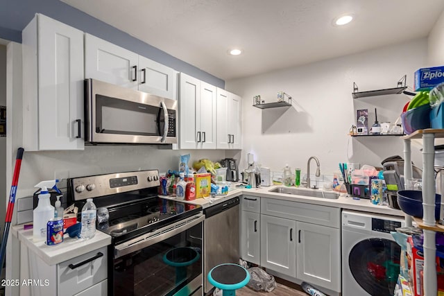 kitchen with washer / clothes dryer, sink, white cabinets, and appliances with stainless steel finishes