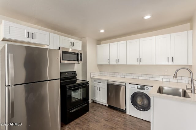 kitchen featuring washer / dryer, white cabinetry, and appliances with stainless steel finishes