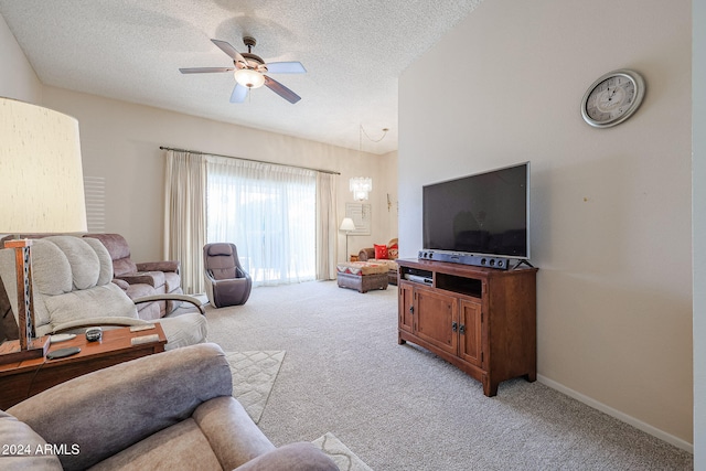 living room featuring light carpet, ceiling fan, and a textured ceiling