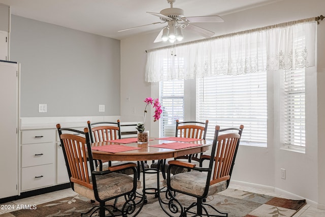 dining room with ceiling fan and light tile patterned floors