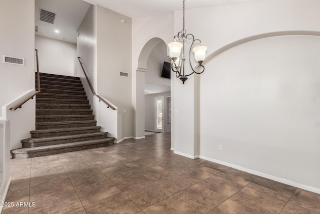 interior space featuring a high ceiling and a notable chandelier