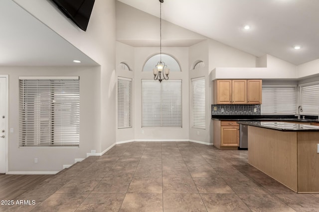 kitchen with tasteful backsplash, sink, pendant lighting, and high vaulted ceiling