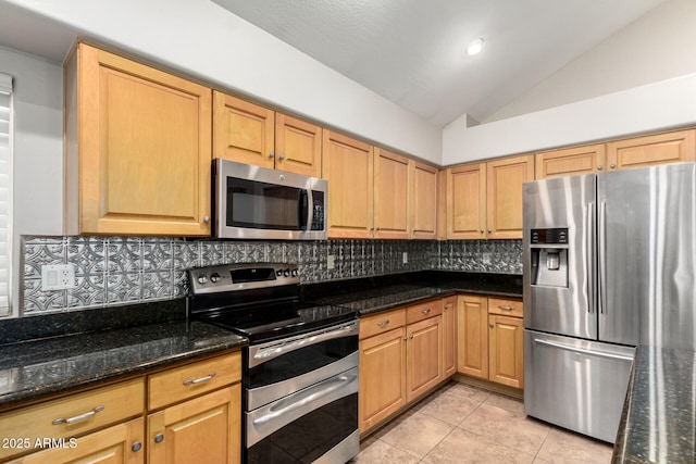 kitchen with dark stone countertops, decorative backsplash, stainless steel appliances, and lofted ceiling