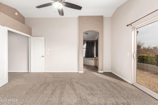 carpeted spare room featuring ceiling fan and lofted ceiling