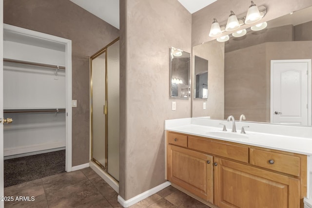 bathroom featuring walk in shower, vanity, and tile patterned flooring