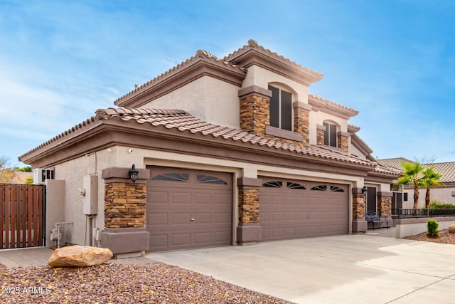 mediterranean / spanish home with a garage